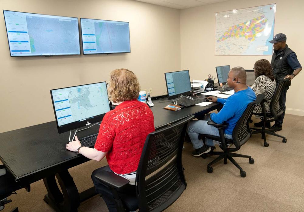 I&J dispatch staff monitoring rides on wall-mounted screens